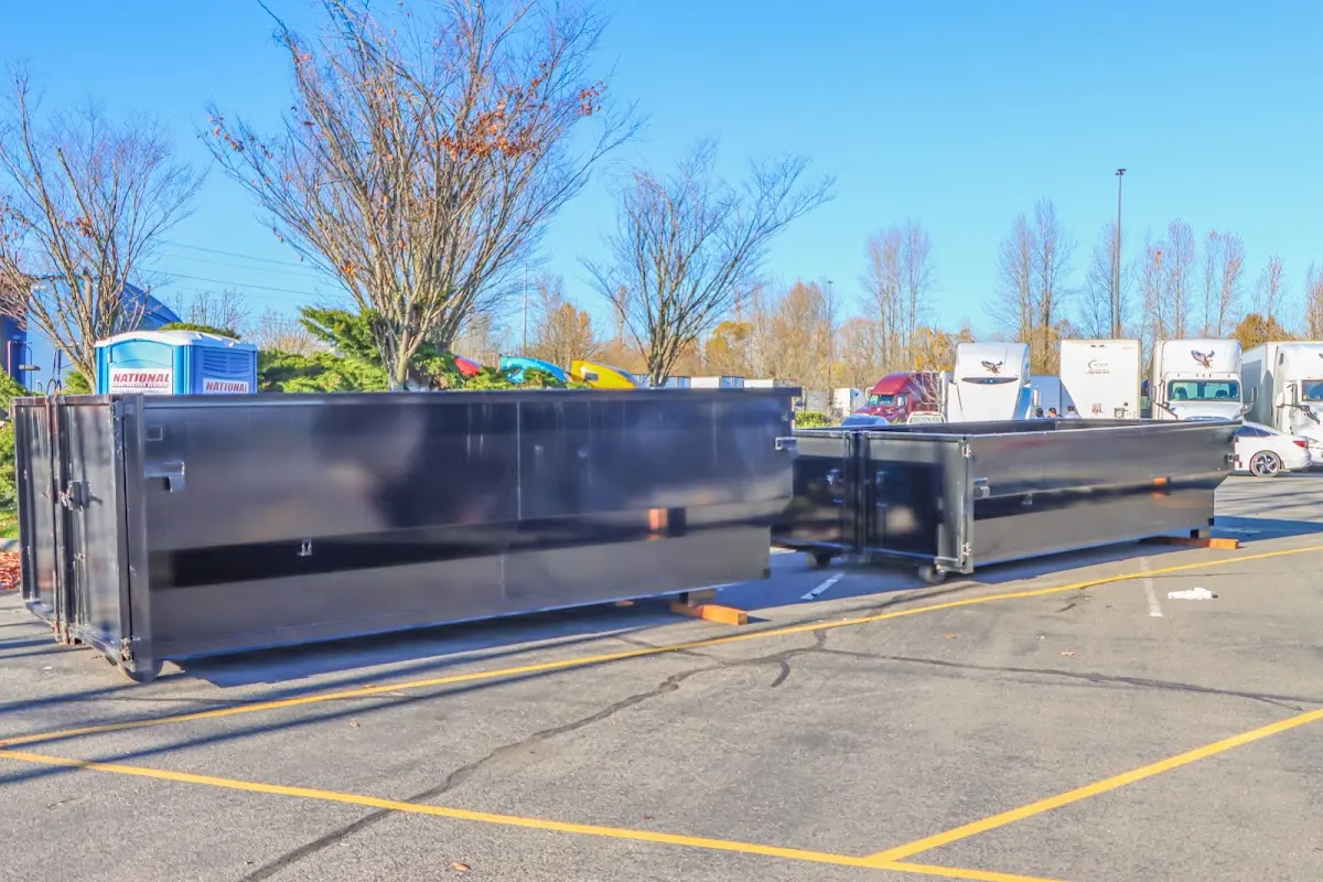 Professional dumpster rental service with roll-off container on residential driveway in Euless